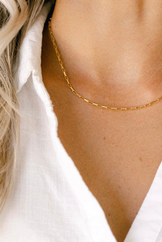 Gold chain necklace on white shirt