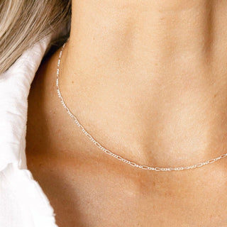 Delicate silver necklace on a woman's neck