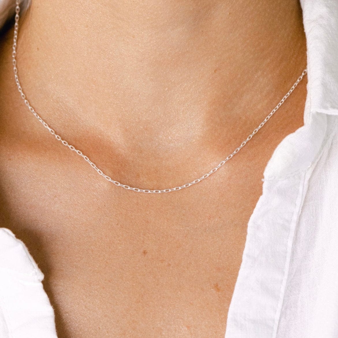 Silver necklace on a person, image 2de64d4b