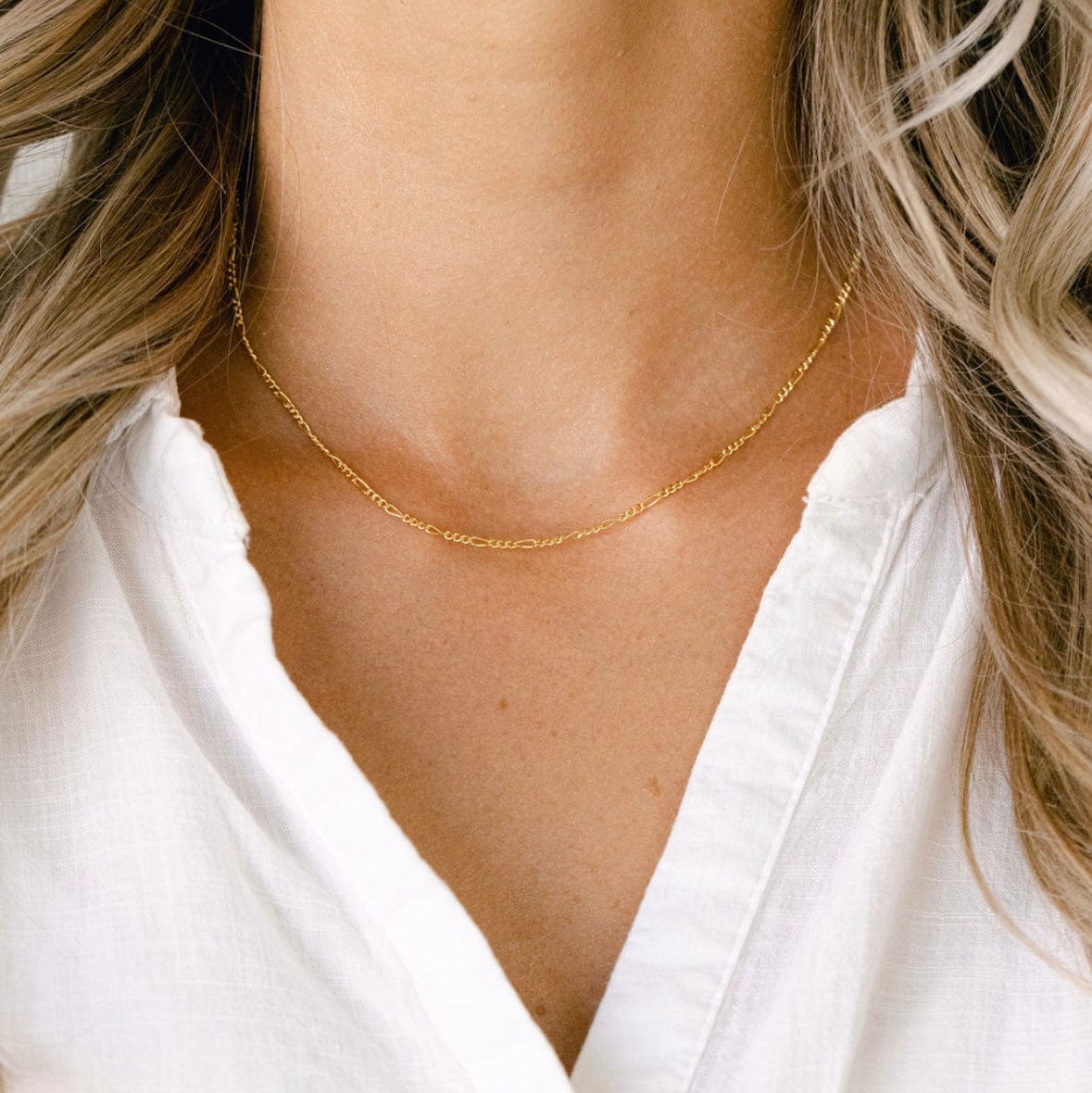Gold chain necklace on a woman