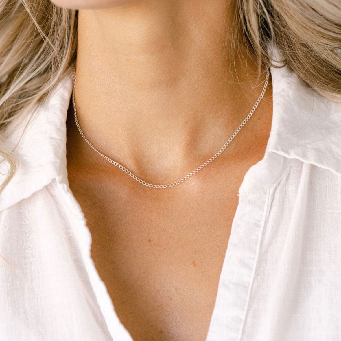 Woman wearing delicate silver necklace