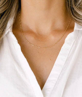 Gold chain necklace on white shirt