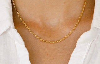 Gold chain necklace on white shirt