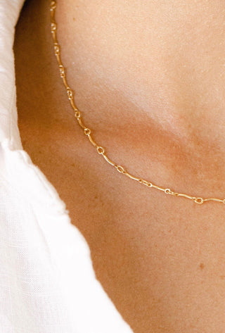 Gold chain necklace on neck