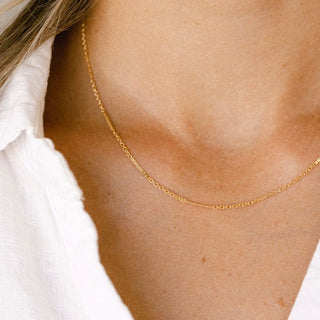 Gold chain necklace on woman's neck