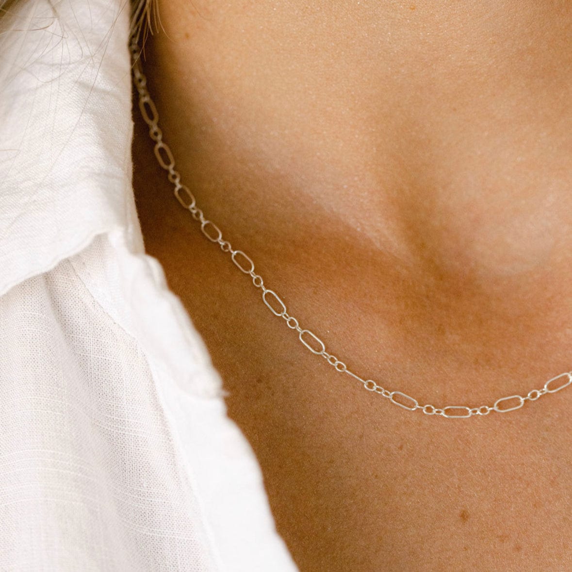 Gold chain necklace on a woman