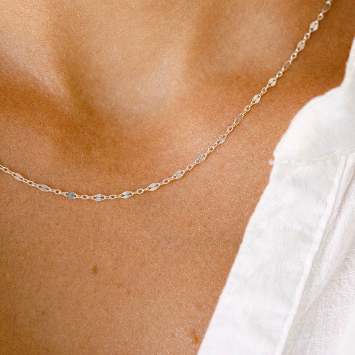 Delicate gold necklace on a woman's neck