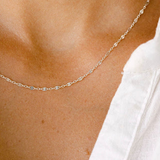 Delicate gold necklace on a woman's neck