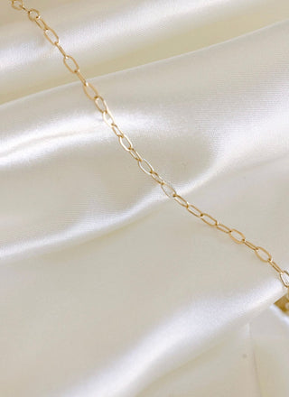 Gold chain necklace on satin