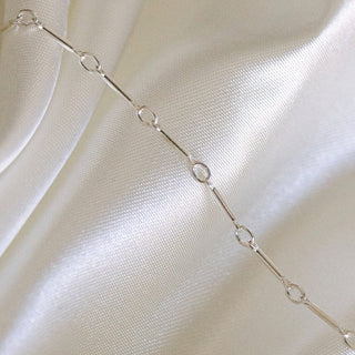 Silver chain necklace on satin
