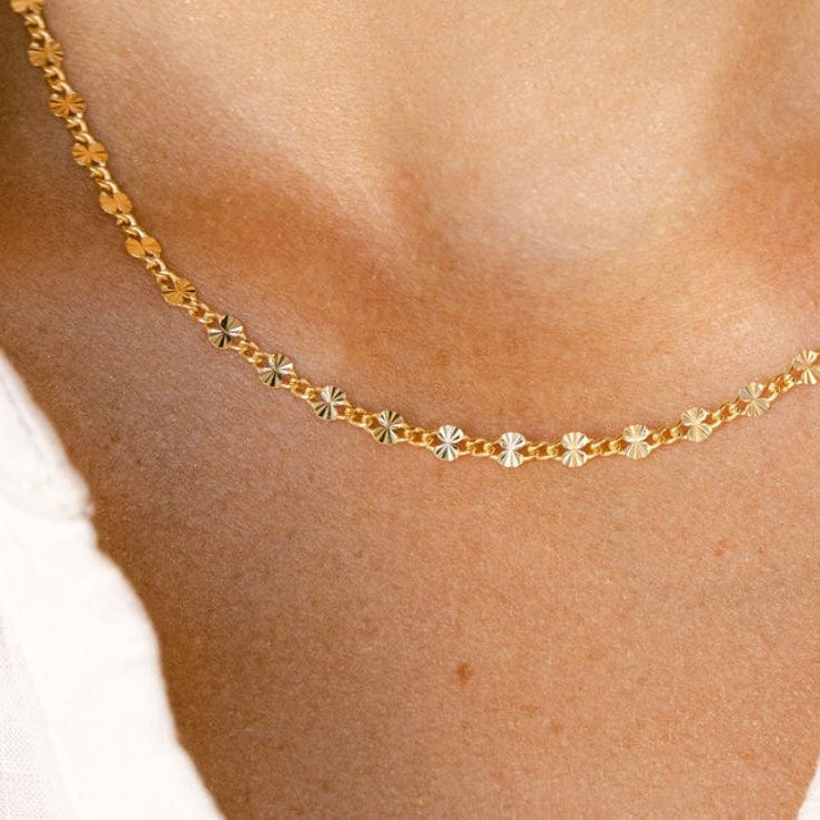 Gold necklace on neckline