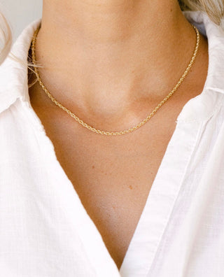 Gold rope chain necklace on white shirt