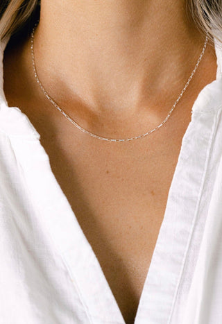 Delicate silver necklace on a woman