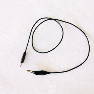 Black alligator clip and wire on white background