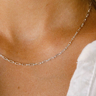 Silver chain necklace on a woman's neck