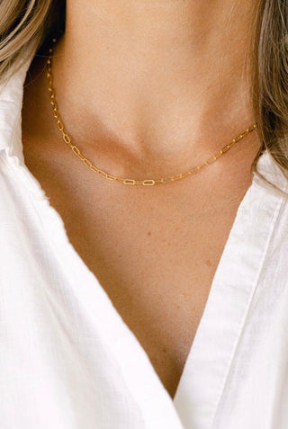Gold chain necklace on white shirt