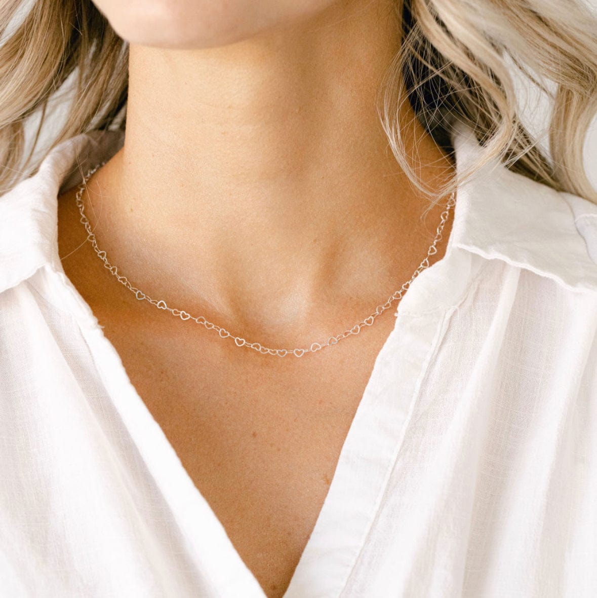 Gold necklace on white shirt