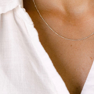Gold chain necklace on white shirt