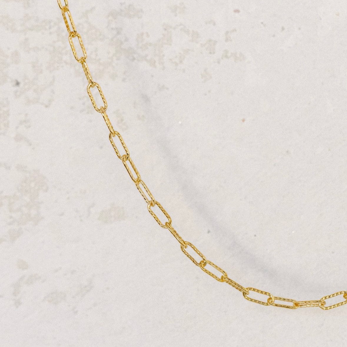 Gold chain necklace on white background