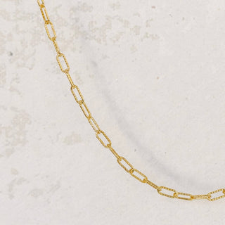 Gold chain necklace on white background