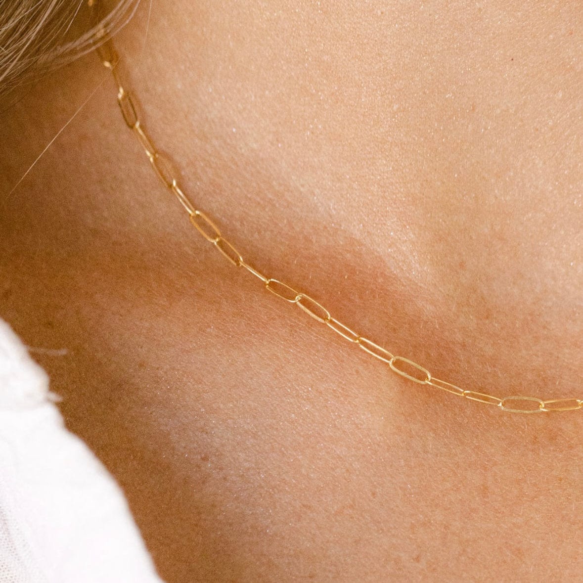 Gold chain necklace on neck