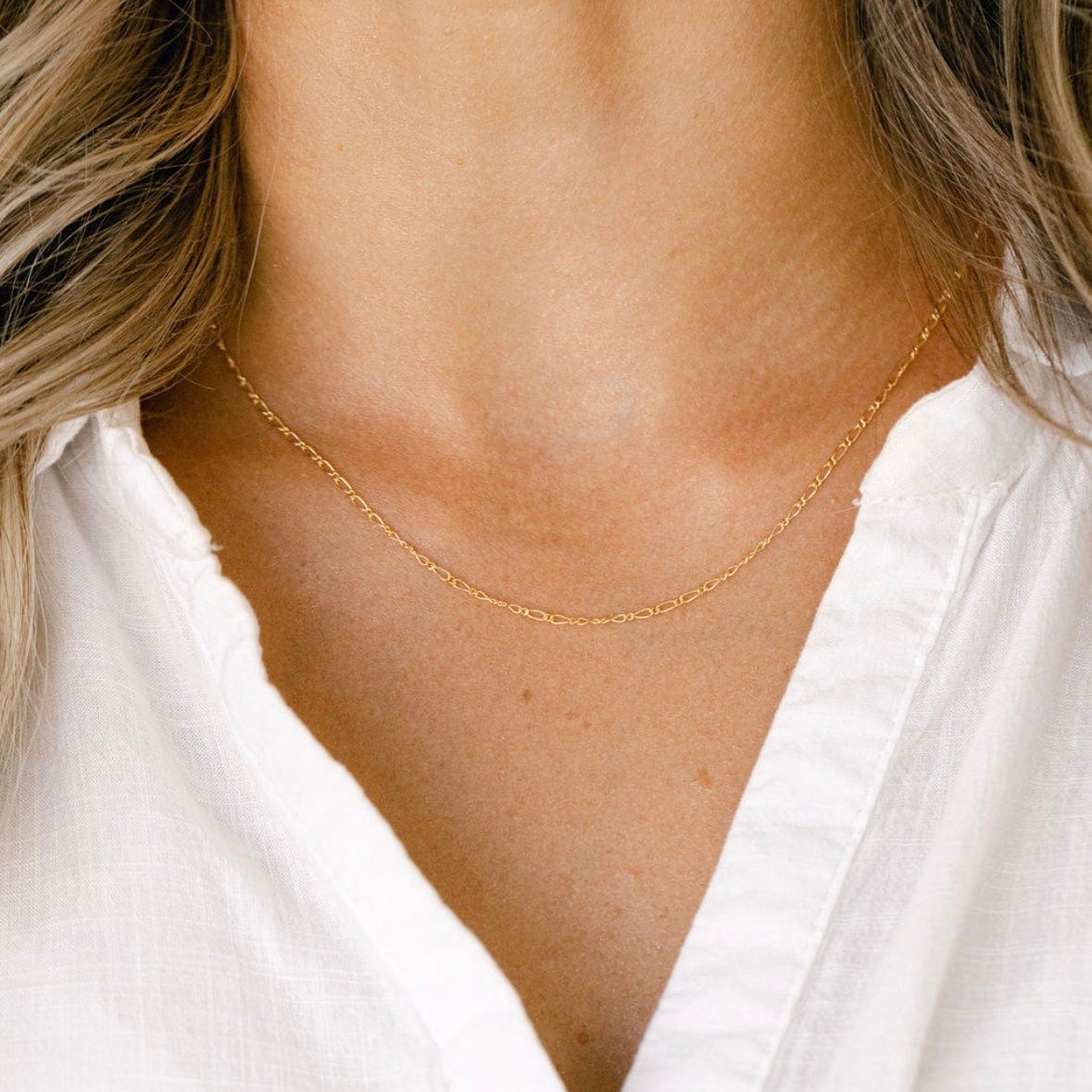Gold necklace on white shirt