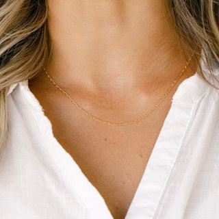 Gold necklace on white shirt