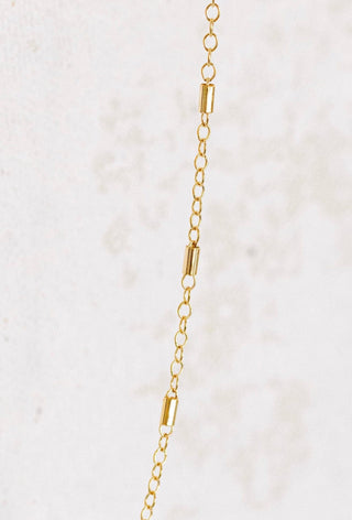 Gold chain necklace with cylindrical accents