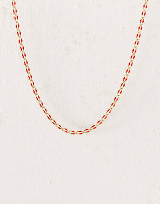 Gold chain necklace with red accents