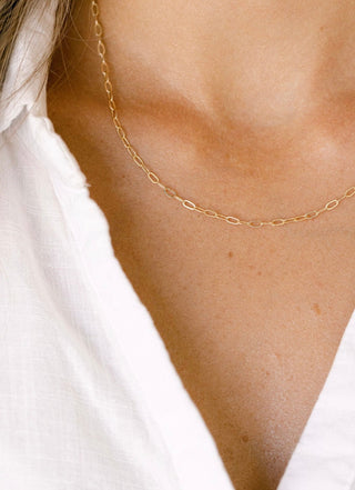 Gold chain necklace on a white shirt