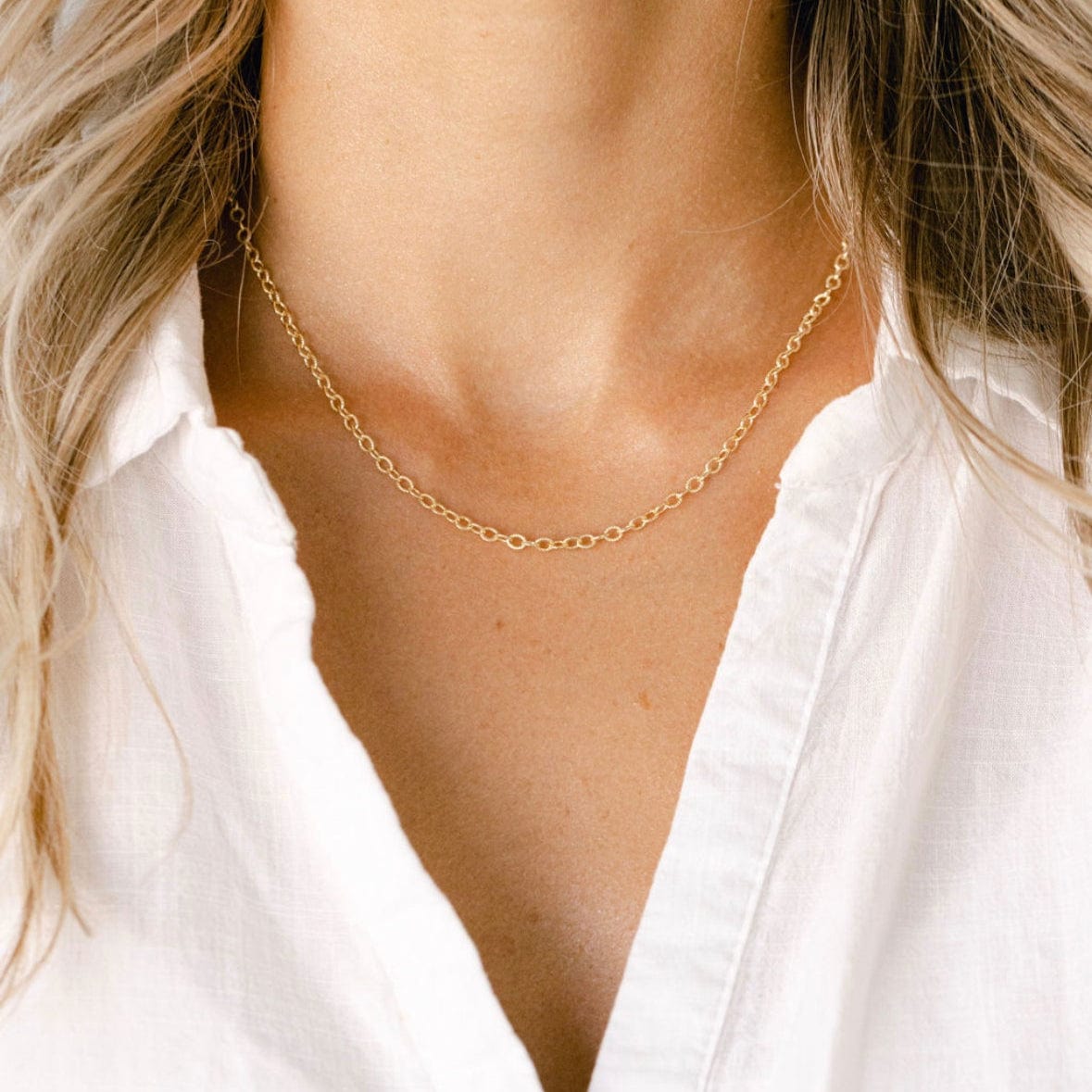 Gold chain necklace on white shirt