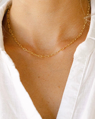 Gold chain necklace on white shirt