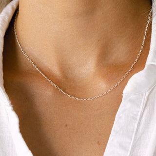 Delicate silver necklace on a woman's neck