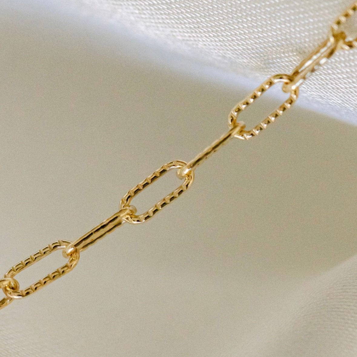 Gold chain necklace on white background