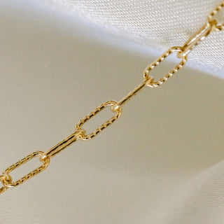 Gold chain necklace on white background