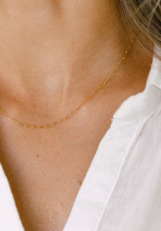 Delicate gold chain necklace on a woman
