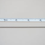 Metallic chain with a ruler for scale on a light gray background
