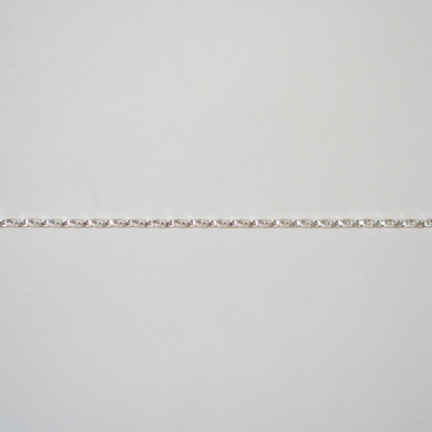 Silver bracelet on a light gray background