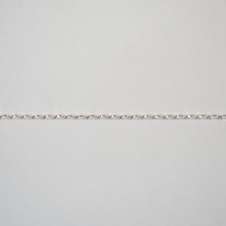 Silver bracelet on a light gray background