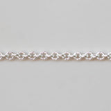 Silver chain bracelet on a light gray background
