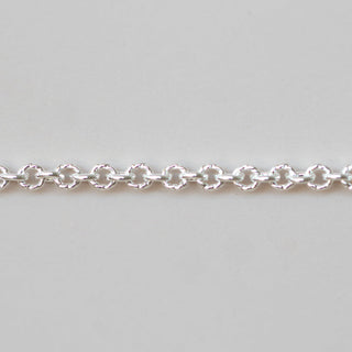 Silver chain bracelet on a light gray background
