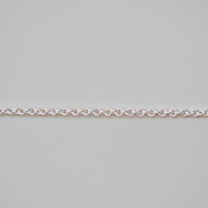 Silver chain on a light gray background