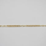 Gold chain on a light gray background