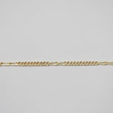 Gold chain on a light gray background