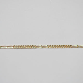 Gold chain on a light gray background
