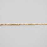 Gold chain on a light gray background