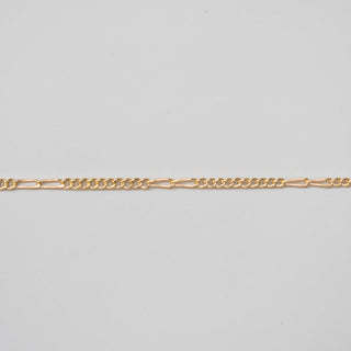 Gold chain on a light gray background