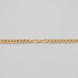 Gold chain on a light gray background
