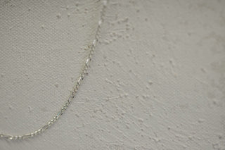 Silver chain on textured white background (sfig5)