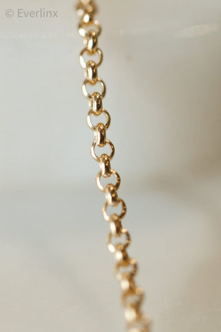 Gold-colored chain link necklace.